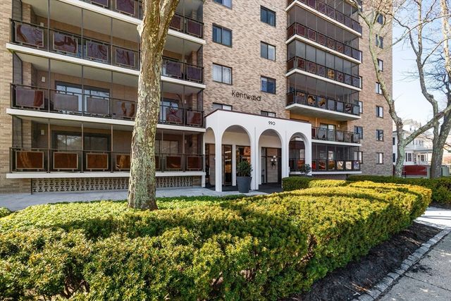 a front view of a building with a garden