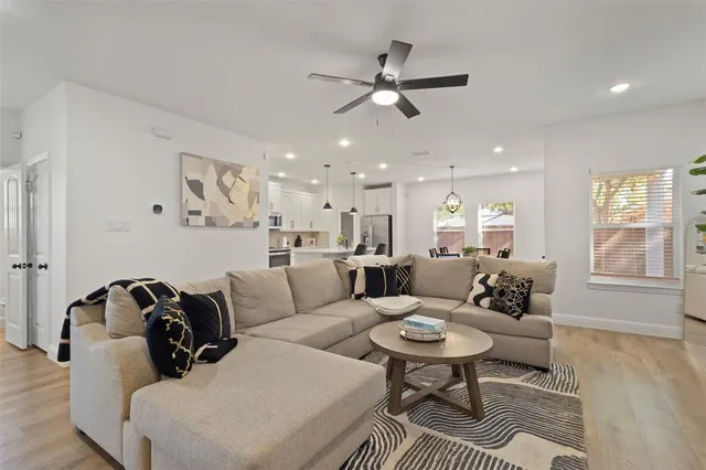 a living room with furniture and a wooden floor