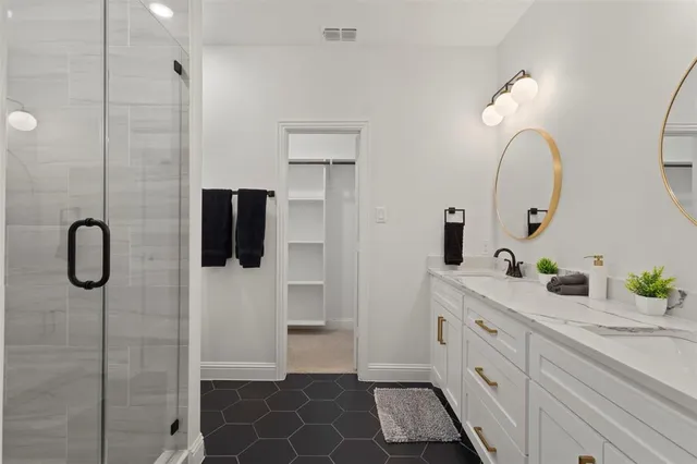 a bathroom with a double vanity sink and a mirror