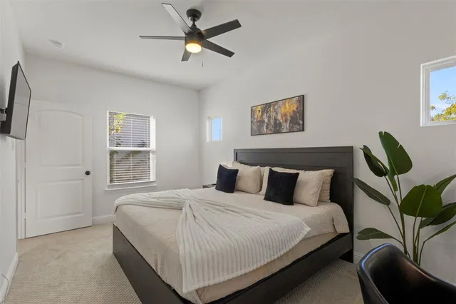 a bedroom with a bed and a painting on the wall