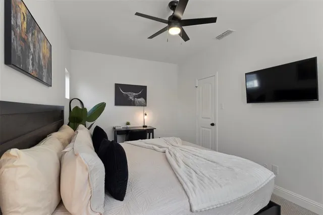 a bedroom with a bed and a flat screen tv