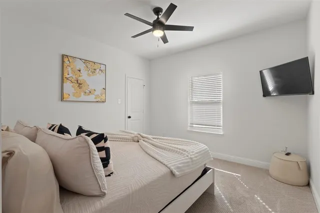 a bedroom with a bed and a television