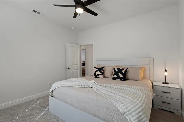 a bedroom with a bed and ceiling fan