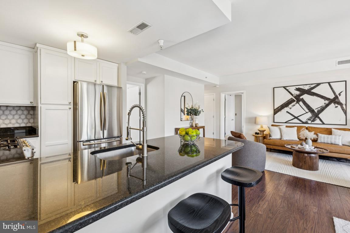 355 I Street Southwest, Unit 501 Washington, DC 20024 - Photo 11 of 44 a kitchen with stainless steel appliances granite countertop a sink a stove and a refrigerator