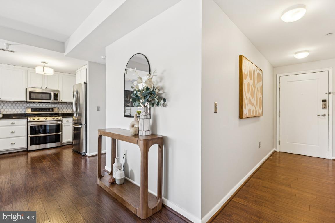 355 I Street Southwest, Unit 501 Washington, DC 20024 - Photo 15 of 44 a view of entryway with kitchen and wooden floor