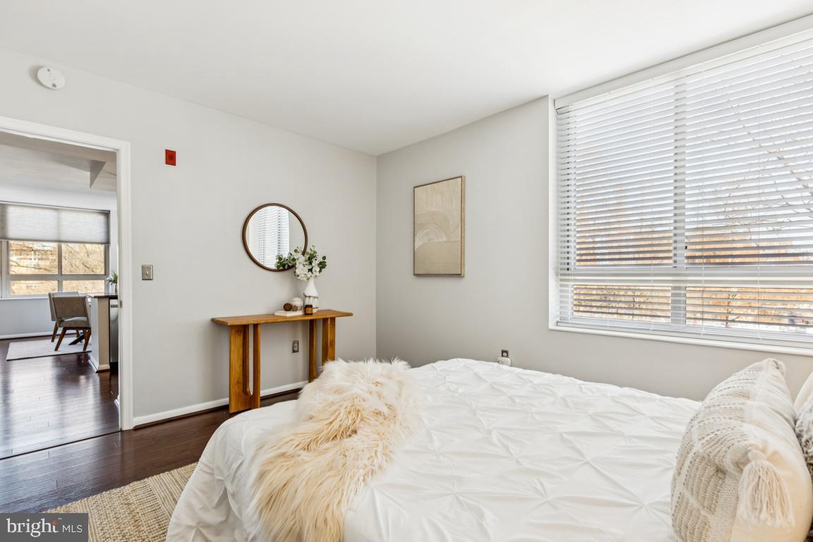 355 I Street Southwest, Unit 501 Washington, DC 20024 - Photo 20 of 44 a bedroom with a large bed and a chandelier