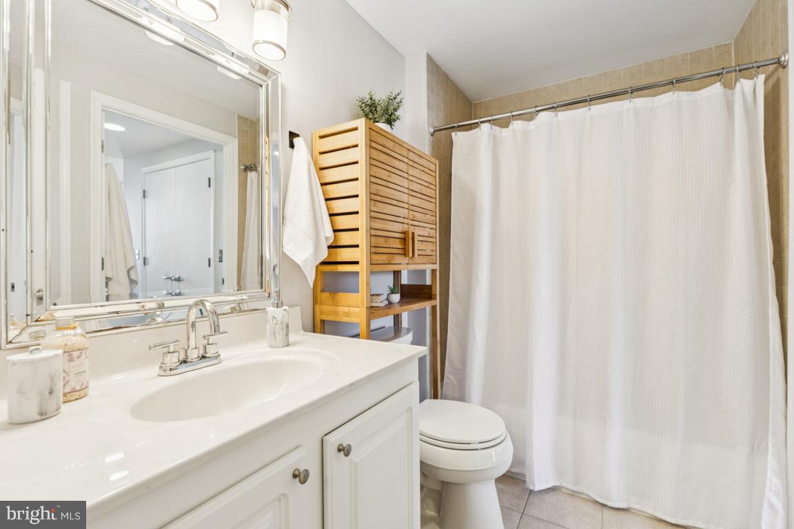 355 I Street Southwest, Unit 501 Washington, DC 20024 - Photo 24 of 44 a bathroom with a sink a toilet and a mirror