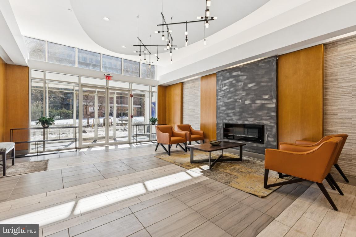 355 I Street Southwest, Unit 501 Washington, DC 20024 - Photo 35 of 44 a living room with patio furniture and a fireplace