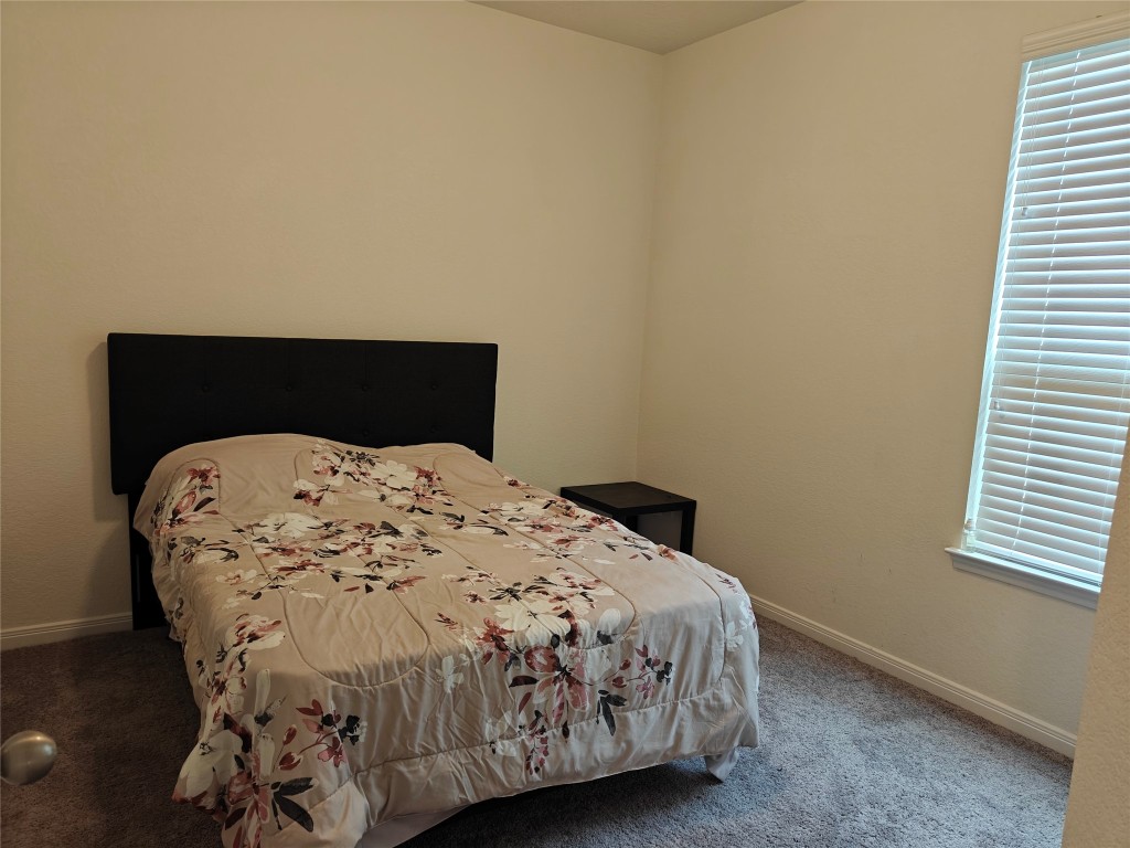 1270 Glendora Drive Rosharon, TX 77583 - Photo 12 of 43 a bed sitting in a bedroom next to a window