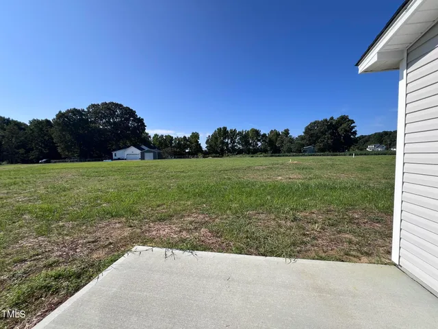 a view of a garden with a building in the background