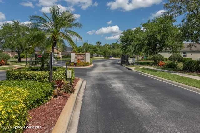 a sign board with buildings in the background