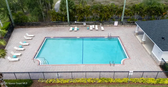 an aerial view of a house with a garden and lake view