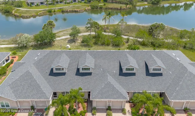 an aerial view of a house with a lake view