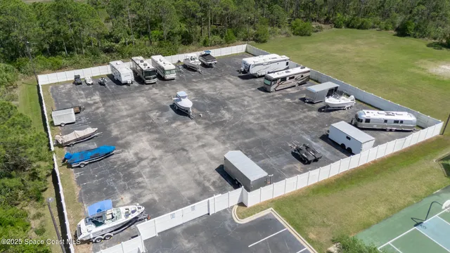 an aerial view of a house with outdoor space and lake view