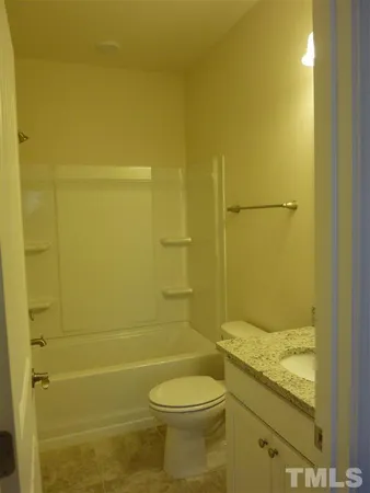 a bathroom with a toilet and shower