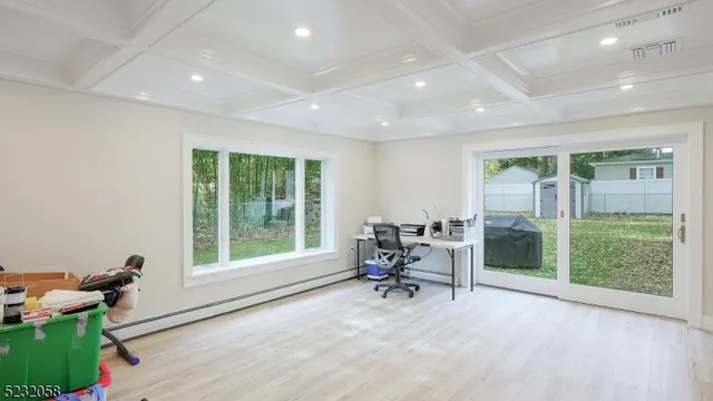 a view of a work space with wooden floor and a floor to ceiling window