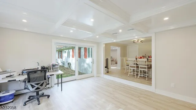 a view of a workspace with furniture and a window