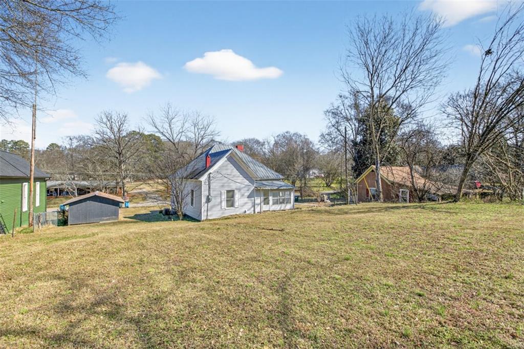 246 Spring Street Commerce, GA 30529 - Photo 22 of 23 a view of a house with a yard and garage