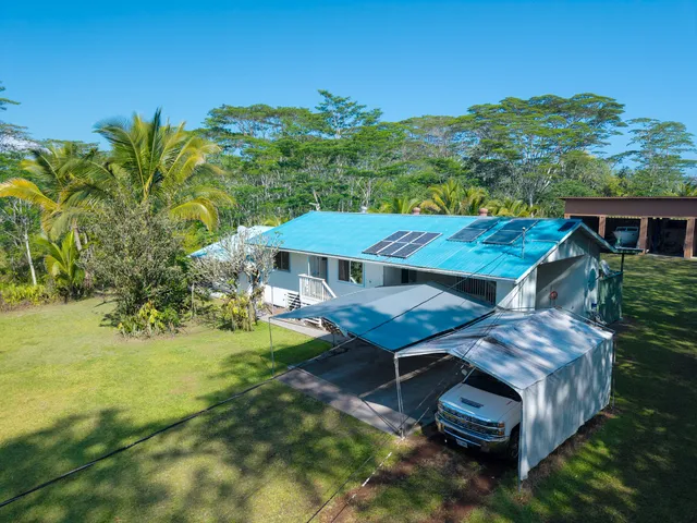 a view of a house with backyard porch and furniture