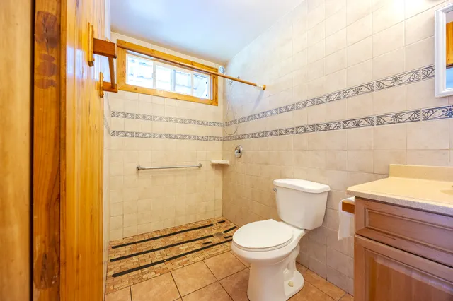 a bathroom with a toilet and a shower
