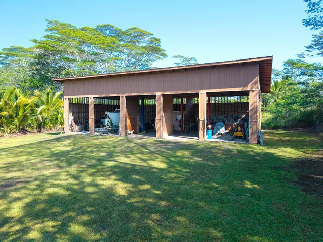 a view of a house with a backyard porch and sitting area