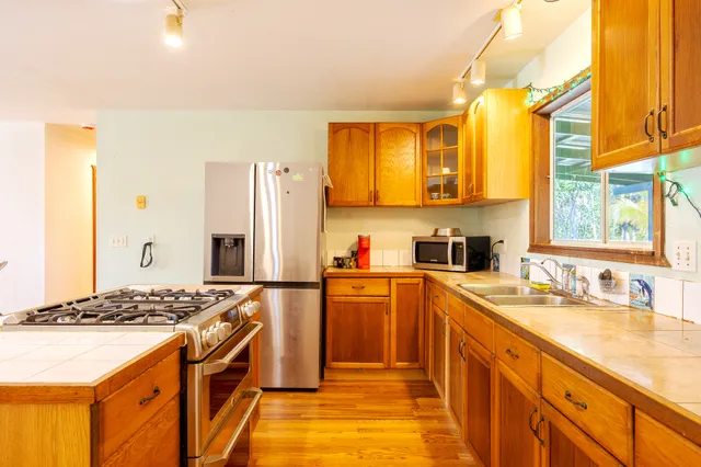 a kitchen with a sink stove and refrigerator