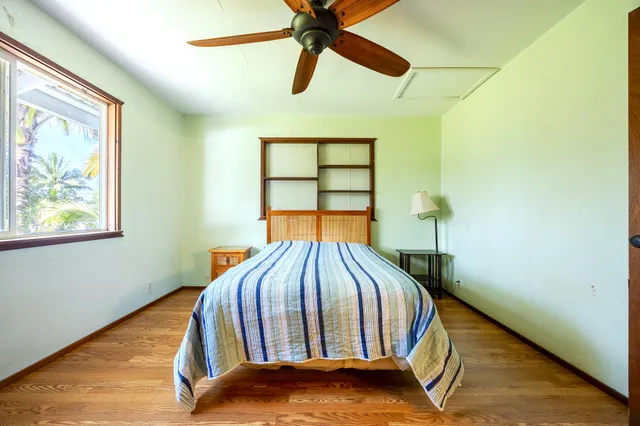 a bed sitting in a bedroom next to a window