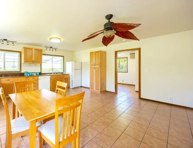 a view of a dining room with furniture and a chandelier