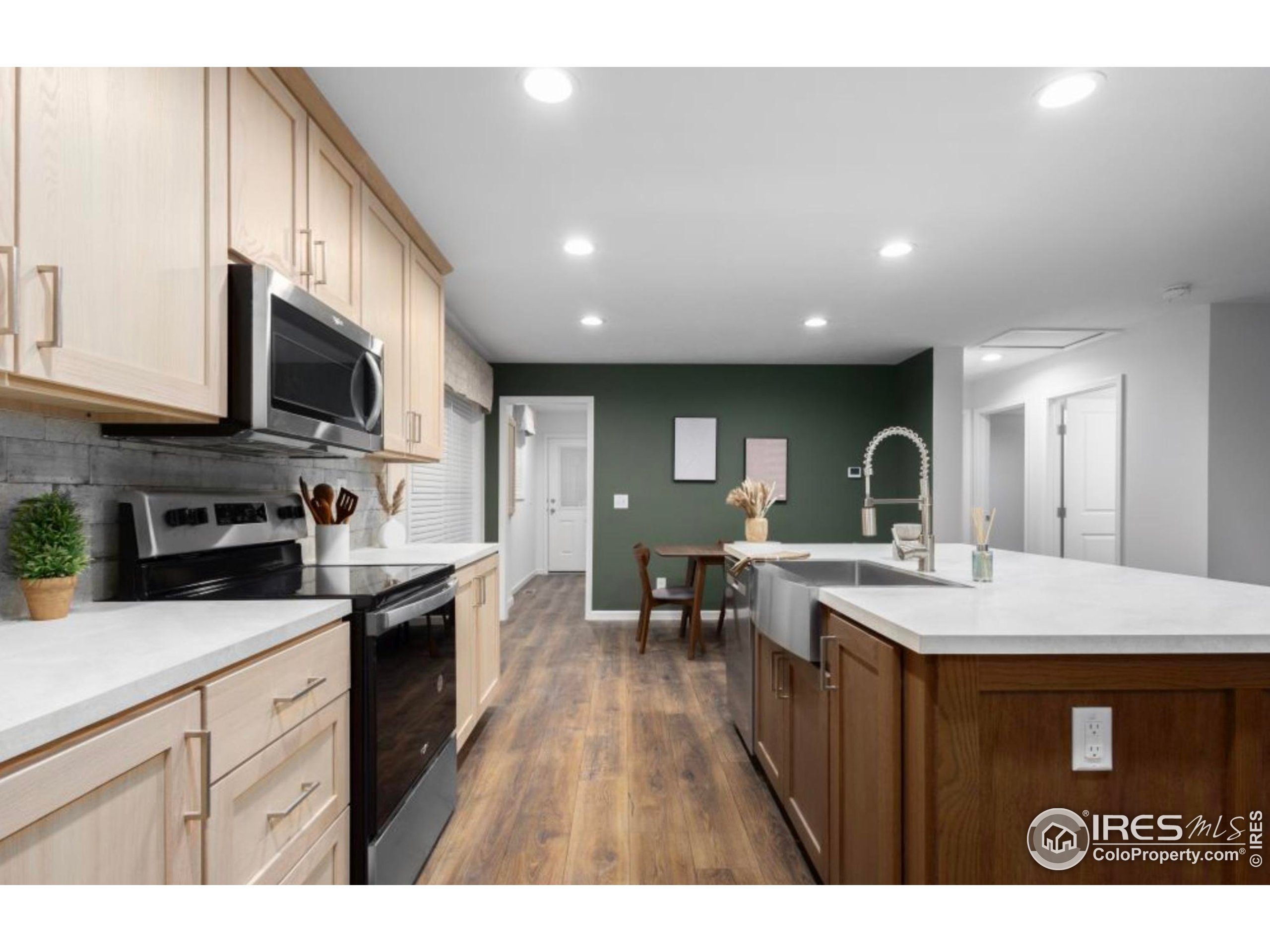 0 3rd Street Carr, CO 80612 - Photo 2 of 8 a kitchen with stainless steel appliances granite countertop a stove a sink dishwasher and a microwave with wooden floor