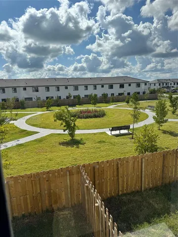 a view of a swimming pool with an outdoor seating and a yard