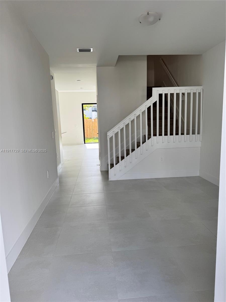 18948 Southwest 344th Terrace, Unit 18948 Homestead, FL 33034 - Photo 9 of 17 a view of staircase and hallway