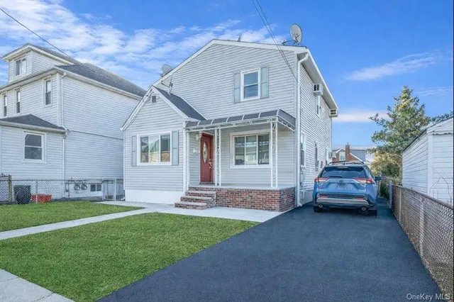 a front view of a house with a garden