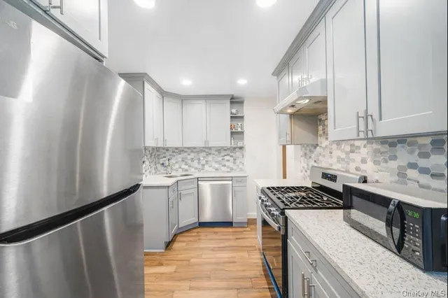 a kitchen with a refrigerator sink and stove