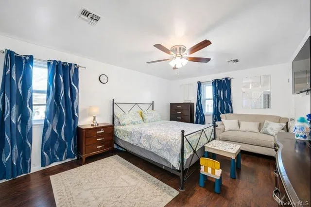 a bedroom with a bed couch and a window