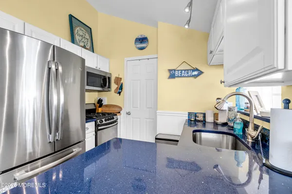 a kitchen with a sink appliances and cabinets
