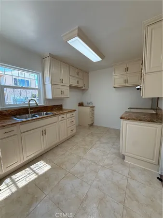 a kitchen with a sink and cabinets