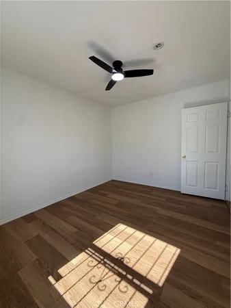 a view of a room with wooden floor