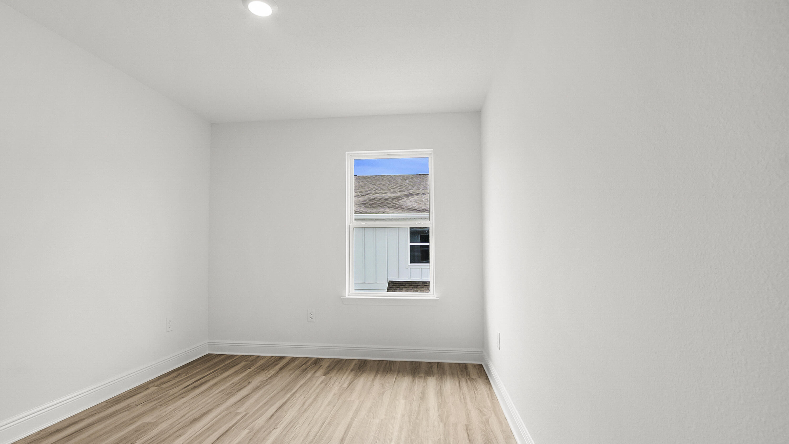 55 Phoenix Street Santa Rosa Beach, FL 32459 - Photo 32 of 34 a view of an empty room with wooden floor and a window