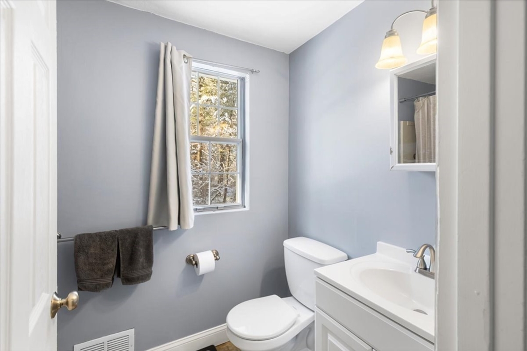 104 Newcomb Street, Unit E Norton, MA 02766 - Photo 11 of 21 a bathroom with a toilet sink and mirror