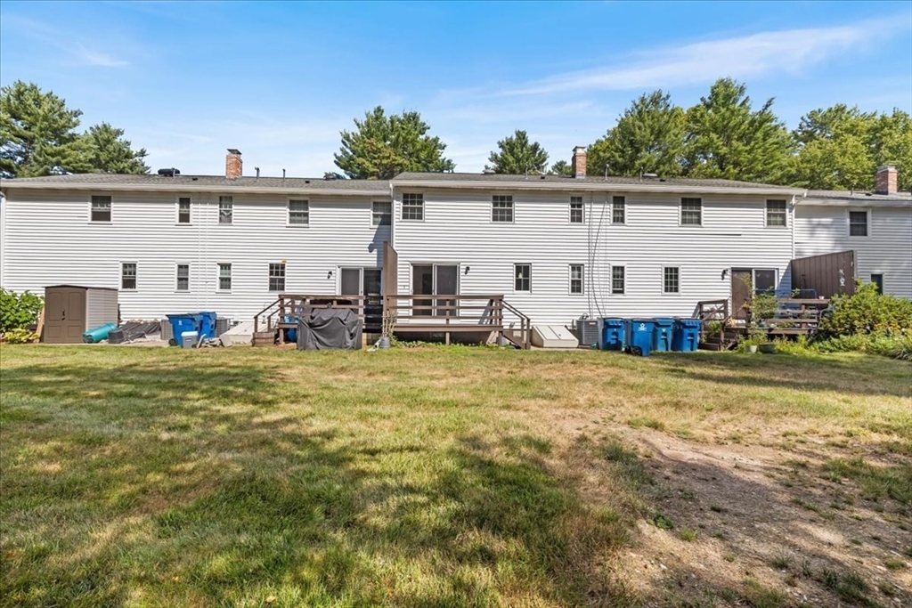 104 Newcomb Street, Unit E Norton, MA 02766 - Photo 17 of 21 a view of a swimming pool with chairs
