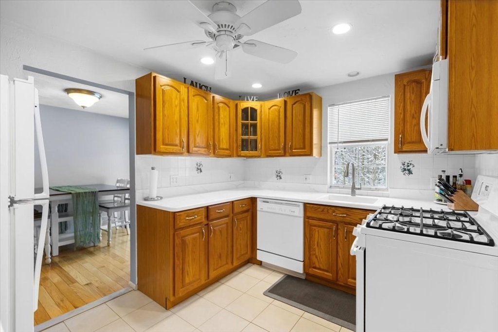 104 Newcomb Street, Unit E Norton, MA 02766 - Photo 3 of 21 a kitchen with a sink stove top oven and cabinets