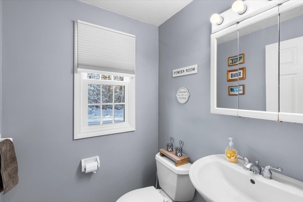 104 Newcomb Street, Unit E Norton, MA 02766 - Photo 6 of 21 a bathroom with a toilet sink and mirror