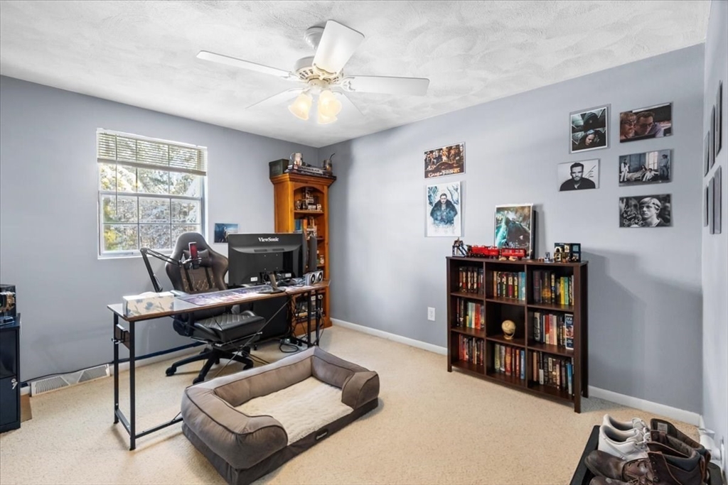 104 Newcomb Street, Unit E Norton, MA 02766 - Photo 9 of 21 a work room with furniture and a bookshelf