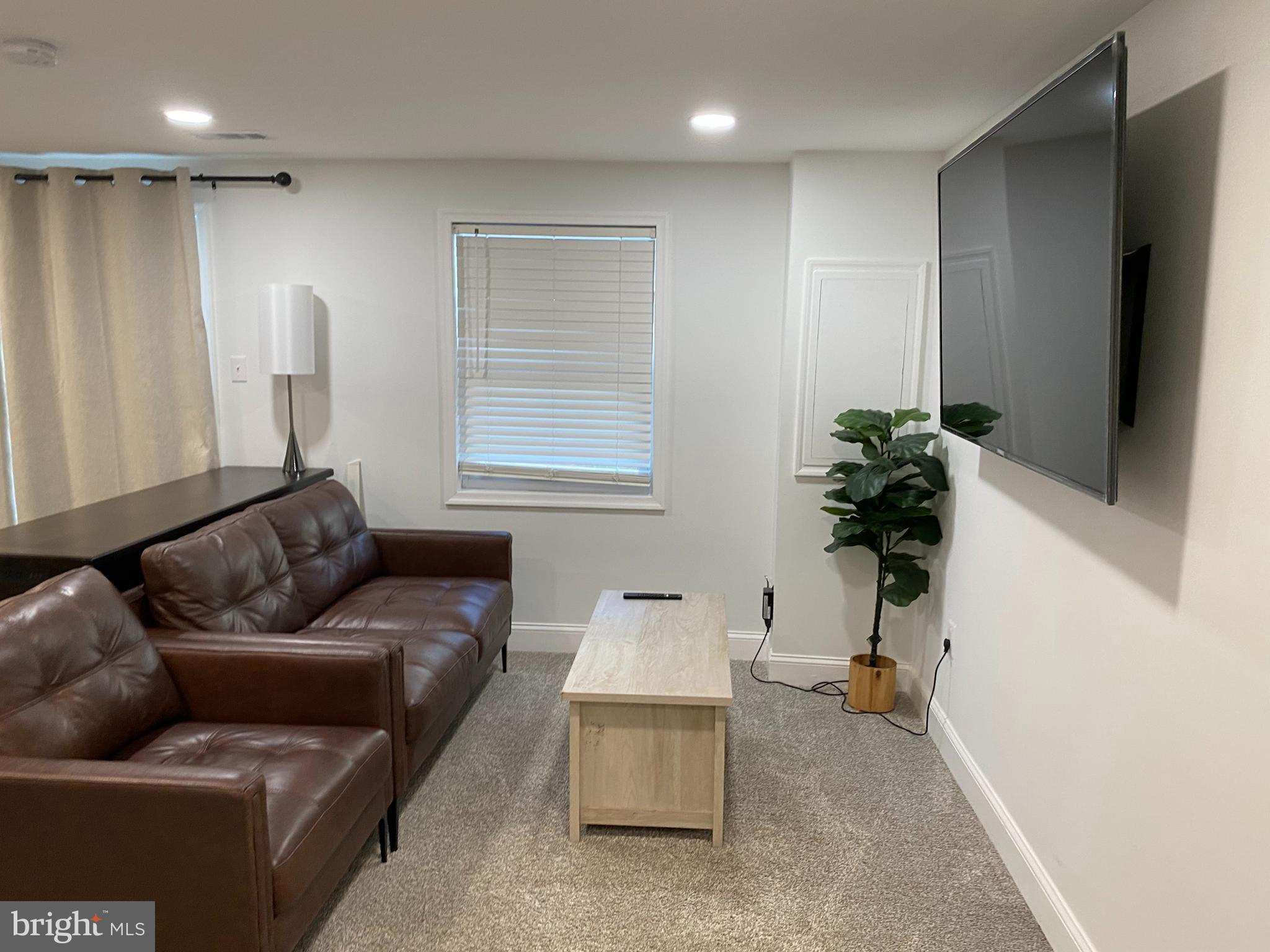 7416 Rhondda Drive, Unit BASEMENT APARTMENT Lorton, VA 22079 - Photo 2 of 11 a living room with furniture and a flat screen tv