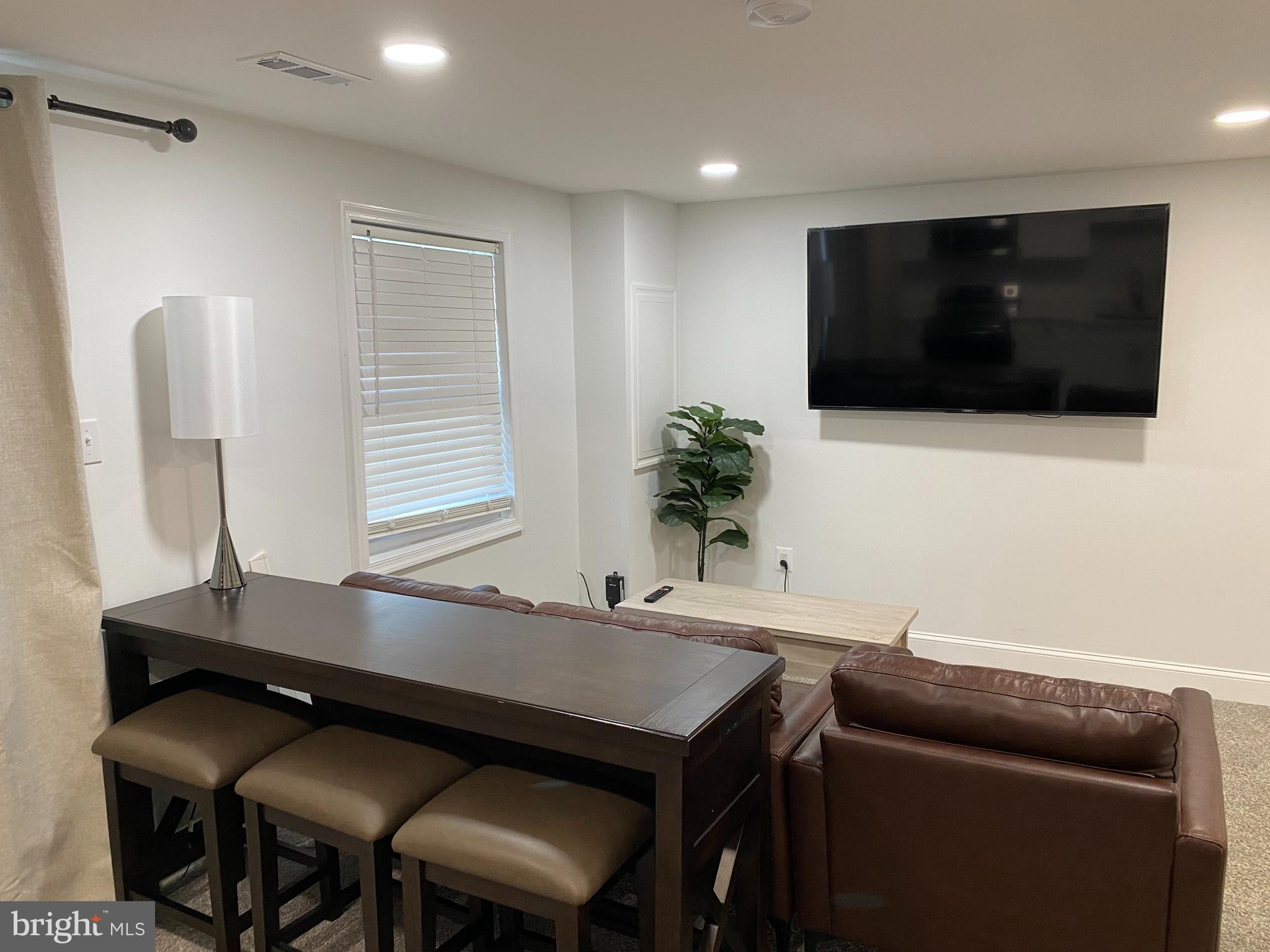 7416 Rhondda Drive, Unit BASEMENT APARTMENT Lorton, VA 22079 - Photo 3 of 11 a living room with furniture and a flat screen tv