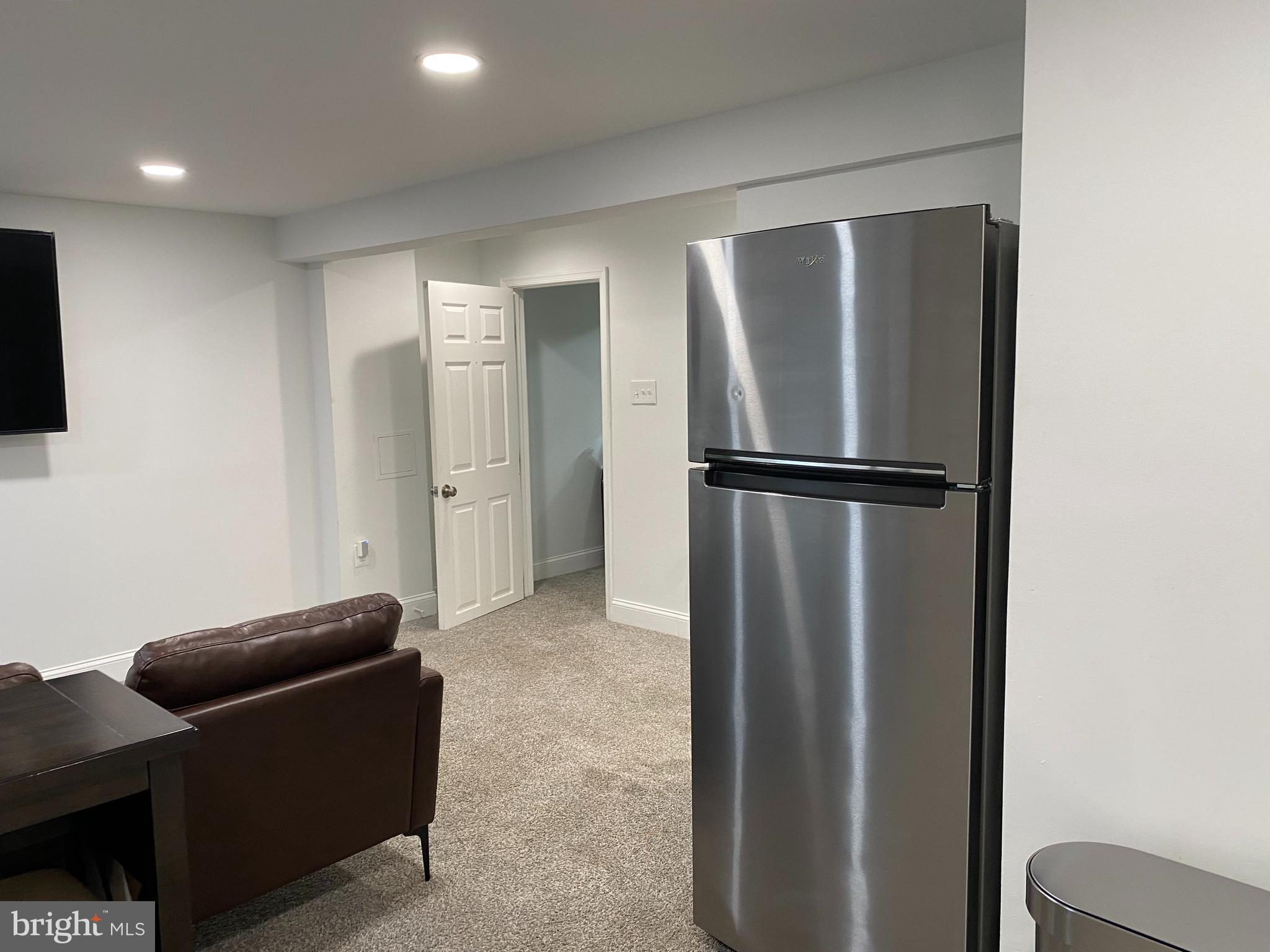 7416 Rhondda Drive, Unit BASEMENT APARTMENT Lorton, VA 22079 - Photo 6 of 11 a view of room with furniture and a refrigerator