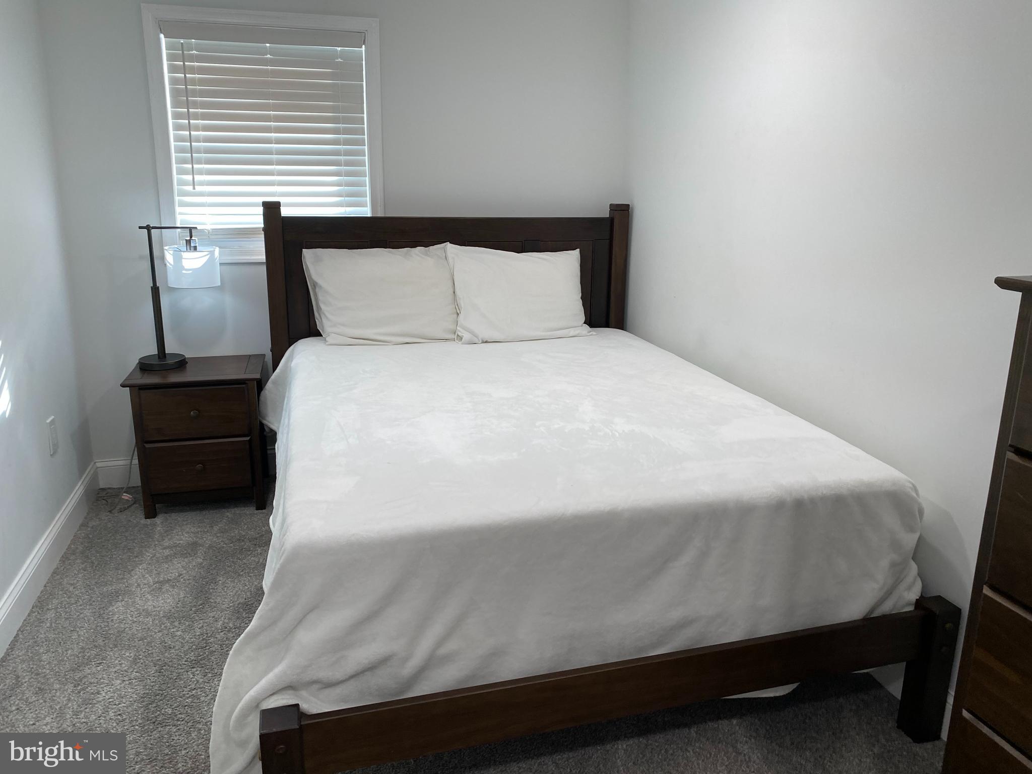 7416 Rhondda Drive, Unit BASEMENT APARTMENT Lorton, VA 22079 - Photo 8 of 11 a bedroom with a bed and window