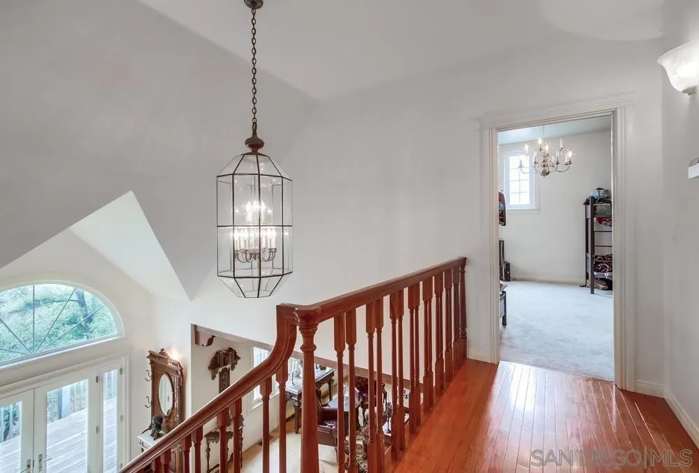 4499 Toyon Mountain Road Julian, CA 92036 - Photo 19 of 50 a view of a hallway with wooden floor windows and stairs