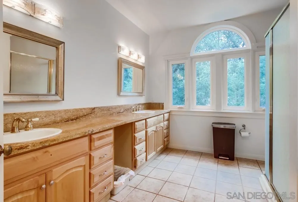 4499 Toyon Mountain Road Julian, CA 92036 - Photo 35 of 50 a spacious bathroom with a granite countertop sink and a large mirror