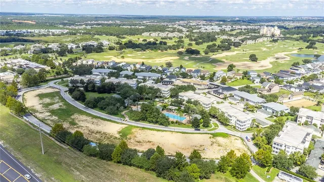 an aerial view of lake and residential houses with outdoor space
